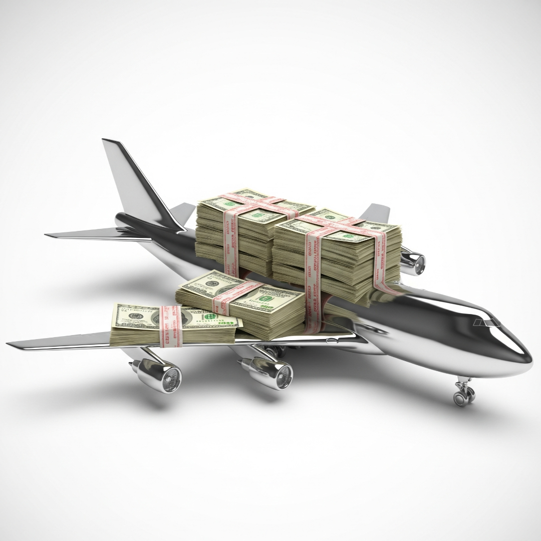 Model airplane with bundles of money on a white background