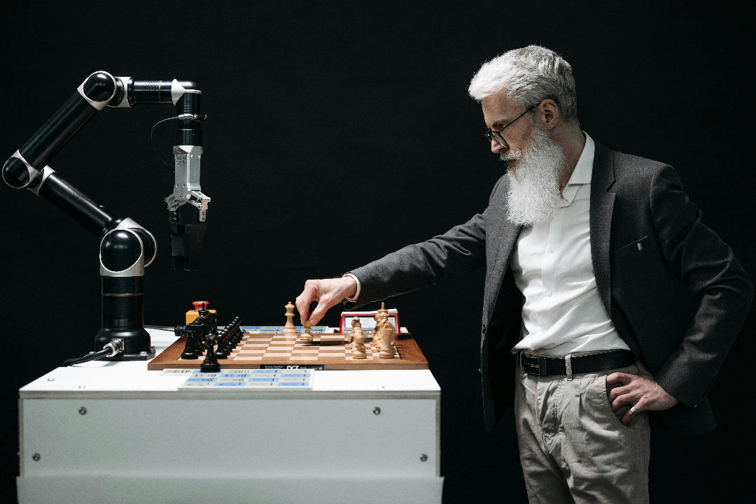 Man playing chess with a robot on a dark background